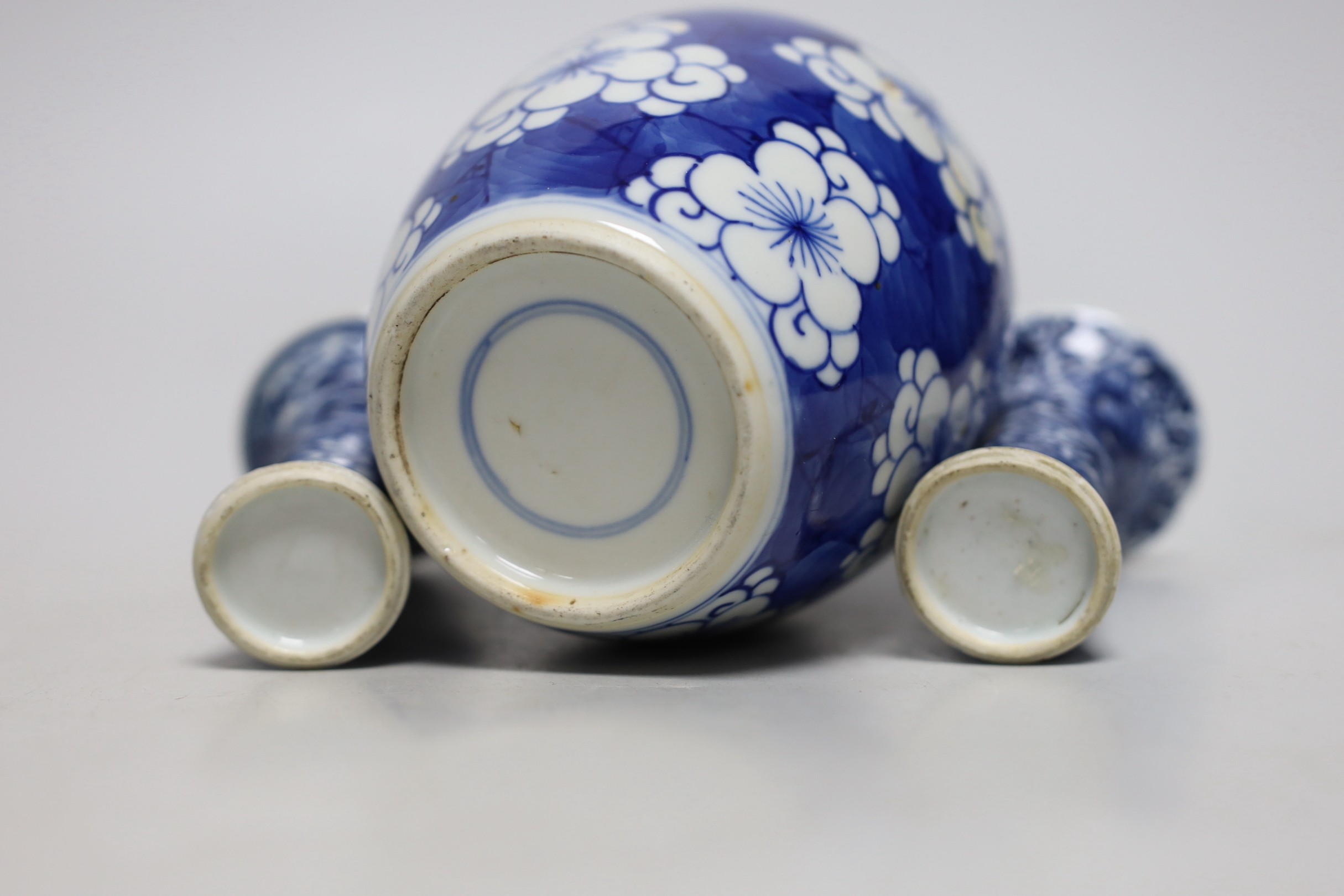A Chinese blue and white prunus jar, two miniature vases and a dish, all Kangxi period, jar 14cms high